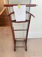 Front view showing hanger, tray, pant rails, casters