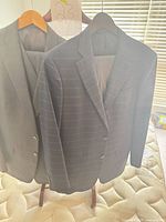 Front view of both jackets hanging, showing pinstripe patterns and two-button closure