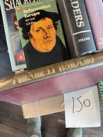Stack of books showing Shackleton, Reformation Europe, The Traders, Grace, maroon hardcover