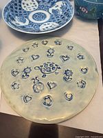 Blue-and-white porcelain plate and ceramic platter in foreground