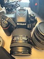 Top view of Nikon D750 with 28-105 mm lens attached, strap visible