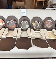 Six boxed Norman Rockwell plates displayed with certificates