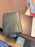 Two padfolios on tabletop