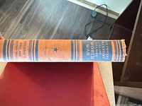Spine of one volume showing title, star motif and wear