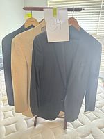 Three jackets on hangers showing front view and colors