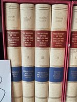 Spines of Volumes I–IV showing titles and numbering inside red slipcase