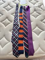 Four neckties laid flat showing full length and colours