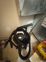 Vacuum with hose, extension wand and floor nozzle visible