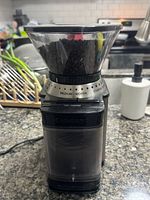 Front view of Cuisinart burr coffee grinder filled with beans
