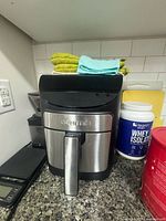 Front view of Gourmia stainless steel and black air fryer on countertop