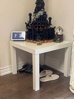 Overall view of white IKEA LACK table in corner