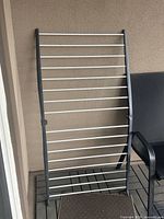 Front view of gray/silver foldable drying rack showing overall structure and rails