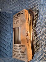 Front view of damaged packaging showing brand and candle ends