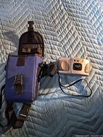 Camera front and Lowepro case on quilted surface