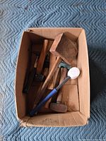 Overview of box showing entire group of mallets and hammers
