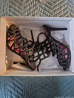 Pair of black strappy heels in box