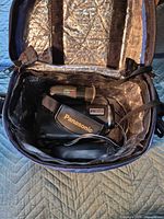 Camcorder and accessories inside open carrying case