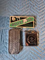 Overall view showing cardboard box, rectangular chrome case, square chrome case