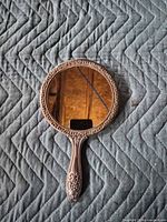 Front view showing round glass mirror and handle