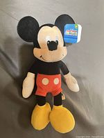Front view of Mickey Mouse plush with tag