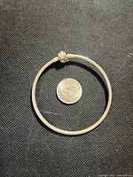 Full view of bangle with quarter for scale