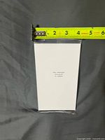 Front view of sealed pack with tape measure showing approx 4-inch width