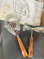 Overall view of strainer, jigger and canvas bag