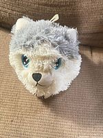 Front view of the Nanco Husky plush ball showing face and eyes