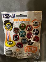 Rear view of sealed Nerf Disc Launcher blind bag detailing 12 collectible discs
