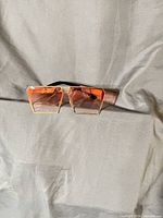 Front view showing square pink gradient lens and gold bridge