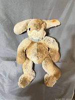 Front view of Steiff Lulac mohair rabbit showing overall appearance and striped neck ribbon