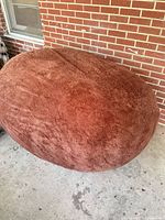 Full view of brown bean bag loveseat on patio