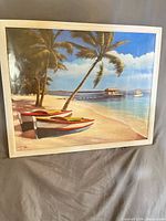 Front view of framed oil painting showing tropical beach scene