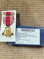 Medal and box front showing NSN and labeling