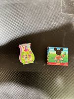 Two miniature packages on black surface