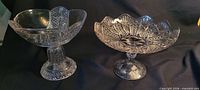 Both pressed glass compotes side by side showing overall design and pedestal bases