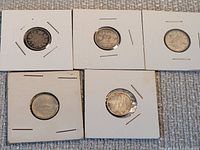 Five Canadian silver dimes in individual 2x2 holders