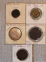 All five coins arranged in 2×2 cardboard flips