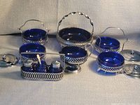 Group shot of cobalt glass pieces in chrome holders