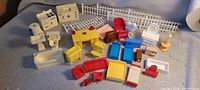 Overall view of assorted plastic dollhouse furniture pieces