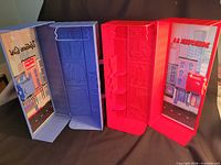 Red and blue doll lockers open to show interiors