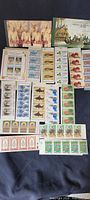 Full assortment overview displaying two booklets and multiple stamp panes on dark background