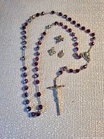 Entire rosary with medals and pin displayed