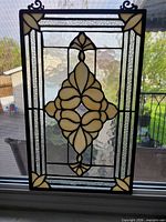 Full view of stained glass panel against window showing overall design