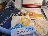 Group view showing Eaton's paper bags, Eaton's tote, two store gift boxes and Crown Royal pouch