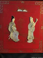 Full view of red wood plaque with two shell figures