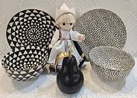 Front view showing two plates, two bowls, doll, pear figurine