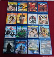 Group of 15 Blu-ray movie cases laid out on red surface