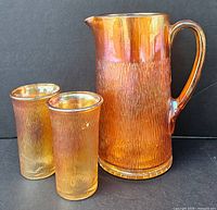Front view of pitcher and two tumblers