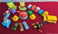 Full view of all toys arranged on red surface